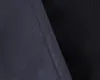 A close-up view of two different fabric textures, one dark blue and the other black, meeting at a seam. Produktbild-Vorschau