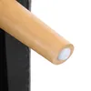 A close-up view of a wooden furniture leg with a white protective cap. Produktbild-Vorschau