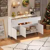A white sideboard with drawers and cabinets is shown in a room with a Christmas tree and decorations. Voir les images du produit