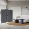 A modern living room with a sofa, coffee tables, and a room divider. Voir les images du produit