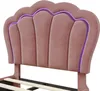A close-up view of a pink upholstered headboard with integrated purple LED lighting. Produktbild-Vorschau