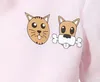 Close-up of cartoon cat and dog faces on a pink garment. Podgląd zdjęcia produktu