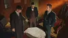 Three men in suits gathered around a table looking at a map. Produktbild-Vorschau