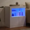 A white sideboard with blue LED lighting inside the open shelf compartment. The sideboard has two cabinet doors on the bottom. It is placed on a wooden floor. Voir les images du produit