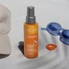 A bottle of Revlon Equave Sun Protection Instant Detangling Conditioner is placed on a white surface next to a baseball cap and sunglasses. Voir les images du produit
