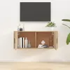 A wall-mounted TV cabinet with doors and shelves, displaying decorative items and books. Voir les images du produit
