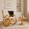 A cozy living room scene with a rocking chair, fireplace, and side table. Náhľad obrázku produktu