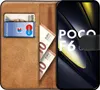 A book-style phone case with a Xiaomi Poco F6 phone inside, showing cards and cash in the wallet section. Produktbild-Vorschau