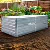 A raised garden bed in a garden setting with plants in the background. Voir les images du produit