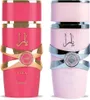 Two perfume bottles, one pink and one light pink, are displayed side-by-side against a white background. Voir les images du produit