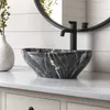 A modern bathroom vanity with a marble vessel sink and a black faucet. Produktbild-Vorschau