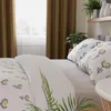 A bedroom scene with bedding and plants. Produktbild-Vorschau