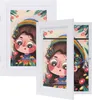 Two white picture frames are displayed, one slightly behind the other, showcasing a colorful illustration of a young girl with a rainbow hat and flowers. Produktbild-Vorschau