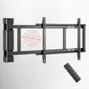 A black electric TV wall mount with a remote control is shown mounted on a white wall. Voir les images du produit