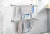 A wall-mounted, foldable drying rack with clothes hanging on it. Produktbild-Vorschau