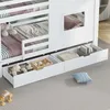 A close-up view of the bottom section of a white bunk bed, showing storage drawers and a small window. Produktbild-Vorschau