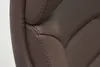 A close-up view of the stitching and texture of a brown leather office chair. Produktbild-Vorschau