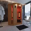 An infrared sauna cabin is set up in a modern bathroom with a large window overlooking a snowy landscape. Produktbild-Vorschau
