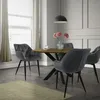 A dining room scene with a round wooden table and four grey velvet chairs. Náhled obrázku produktu