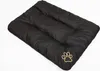 A black dog bed with a gold paw print logo on a white background. Podgląd zdjęcia produktu