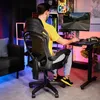 A man is playing a video game in a room with colorful lighting. Produktbild-Vorschau
