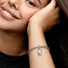 A close-up shot of a woman's arm wearing a Pandora charm bracelet with a snowflake charm. Podgląd zdjęcia produktu