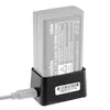 A Godox VB26 battery is shown in its charging dock, connected to a power cable. Podgląd zdjęcia produktu