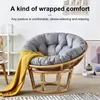 A papasan chair with a gray cushion and yellow throw blanket in a living room setting. Produktbild-Vorschau