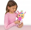 A young girl is holding a baby doll dressed as a unicorn and feeding it a pink popsicle. Anteprima dell’immagine prodotto
