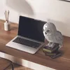 A desk with a laptop, a decorative owl figurine on books, and a diffuser. Produktbild-Vorschau