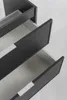 A close-up, high-angle view of a dark gray bathroom vanity with three open drawers, revealing their light gray interiors and silver handles. Anteprima dell’immagine prodotto