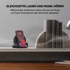 A smartphone charging on a wireless charging stand next to decorative bookends. Produktbild-Vorschau