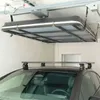 A car roof box lift system mounted to the ceiling of a garage, with a car parked underneath. Produktbild-Vorschau