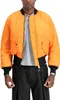A person wearing an orange bomber jacket and black pants. Produktbild-Vorschau