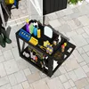 A black rolling workshop cart filled with various tools and cleaning supplies, placed on a paved patio. Podgląd zdjęcia produktu