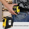 A person is holding a tape measure in their hand, clipped to their jeans pocket. Produktbild-Vorschau