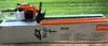 A Stihl hedge trimmer is displayed on its packaging box, with a blurred green background suggesting an outdoor setting. Produktbild-Vorschau