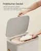 A hand is shown opening the lid of a laundry basket, revealing clothes inside. Text describes the lid's features. Produktbild-Vorschau