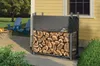 A firewood rack with a cover is shown next to a yellow house, with chairs and a fire pit in the background. Náhľad obrázku produktu