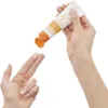 A hand squeezing sunscreen onto fingers. Podgląd zdjęcia produktu