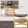 A collage of images showing a round coffee table with a marble-look top and a gold metal frame, featuring two tiers for storage. One image shows the table in a living room setting, and another provides a closer view of the tiered shelves. Náhľad obrázku produktu