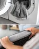 A collage showing a dog bed being washed in a washing machine and a close-up of the dog bed's quilted texture. Produktbild-Vorschau