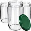 Three clear glass jars are shown with one green lid in the foreground. Podgląd zdjęcia produktu