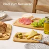A table setting with bamboo cutting boards displaying cheese, olives, grapes, prosciutto, and bread, along with a jar of olive oil. Anteprima dell’immagine prodotto