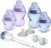 A collection of baby bottles, pacifiers, and a bottle brush arranged on a white background. Voir les images du produit