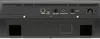 The back panel of a black electronic device, likely a keyboard or synthesizer, showing various ports and vents. Náhľad obrázku produktu