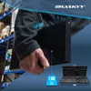 A person is holding a black case, with dimensions and weight indicated by overlays. A set of tools is visible in the lower right corner. Produktbild-Vorschau
