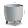 A light gray planter pot with three wooden legs, shown against a white background with dimensions indicated. Produktbild-Vorschau
