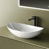 A white oval vessel sink with a black faucet is shown on a green vanity with a ribbed texture. A lit mirror is visible in the background. Produktbild-Vorschau