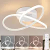 A modern white LED ceiling light with a geometric design, shown in three different lighting conditions and with a remote control. Produktbild-Vorschau